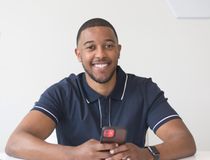 Smiling freelancer at a bright white desk