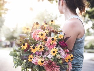 Florist carrying a fresh bouquet for a client order